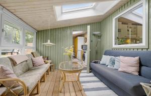 a living room with a couch and a table at Amazing Home In Højby With Wifi in Højby