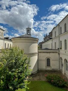 a building with a clock tower on top of it at Hospice St Nicolas in Troyes