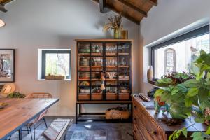 a dining room with a book shelf and a table at Feel Discovery P&P House Douro Valley in Resende