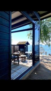 a view of a deck with a view of the water at Moderni rantasauna ja -mökki in Joensuu