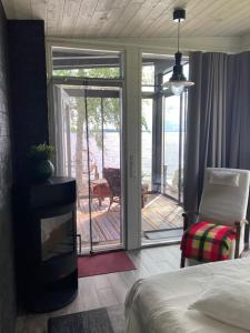 a bedroom with a bed and a view of a patio at Moderni rantasauna ja -mökki in Joensuu +6 photos