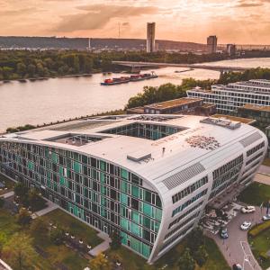 an aerial view of a building next to a river at Kameha Grand Bonn in Bonn