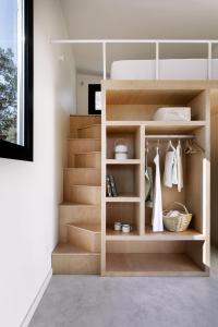 a walk in closet with wooden shelves and stairs at wecamp Cudillero in El Pito