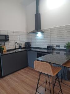 A kitchen or kitchenette at Apartamentos El Llanin