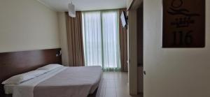 a bedroom with a bed and a large window at Martur Resort in Termoli