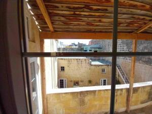 a view of a building from a window at The Gem Farmhouse by Homely in Santa Venera