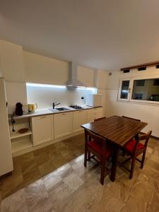 a kitchen with a wooden table and a dining room at B&B Casina Margherita in Monteroni di Lecce