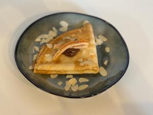 a plate with a piece of food on it at Vila Dora B&B in Požega