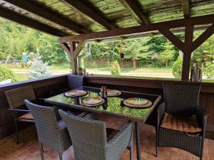 a table with plates of food on a patio at Casa Ada in Arpaşu de Sus