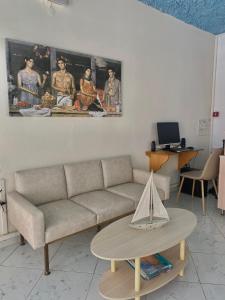 a living room with a couch and a table at FLORIDA HOTEL, ADULTS only in Rhodes Town