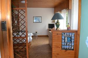 a hallway with a room with a desk and a lamp at Les Fromentines in Saint-Pol-de-Léon