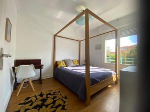 a bedroom with a canopy bed and a desk at Hypercentral flat for 6 in Lorient in Lorient