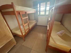 a small room with two bunk beds and a window at Ñandubay1 in Puerto Iguazú