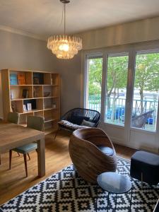 a living room with a chair and a table at Hypercentral flat for 6 in Lorient in Lorient