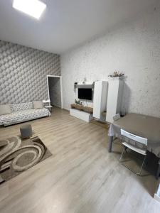 a living room with a table and a television at Catapano's House in Pompei