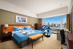 Cama ou camas em um quarto em Shangri-La Chengdu