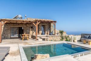 a patio with a swimming pool and a house at Lunar House ll in Vólax