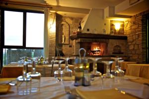 a dining room with a table and a fireplace at Country House Carfagna in Assisi