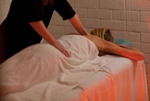 a woman is laying on top of a bed at Hotel Brummell in Barcelona