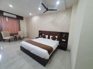 KathuaAkash Hotel Managed By JK Hotels & Resorts的一间卧室配有一张大床和吊扇