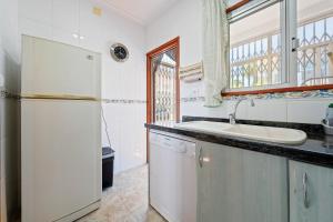 a kitchen with a refrigerator and a sink at Planta Baja La Malvarrosa in Benicarló +15 photos