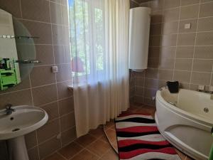 a bathroom with a sink and a toilet and a mirror at Баракат in Chon-Sary-Oy