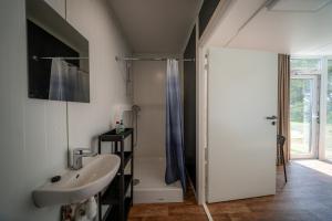 a bathroom with a sink and a shower at BoardHouse Spot in Svencelė