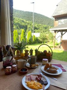 a table topped with plates of breakfast food with a view at GRAN CHALET HOTEL & PETiT SPA WELLNESS in Vielha +61 photos