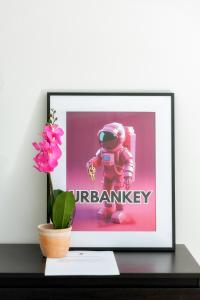 a picture of an astronaut on a table with a flower at UrbanKey Studios - Vienna Neubau in Vienna