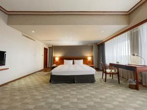 Postel nebo postele na pokoji v ubytování Guide Hotel Hsinchu Zhongyang