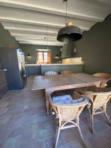 a kitchen with a large wooden table and chairs at Can Casellas in Palau Sator