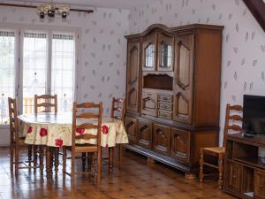 a dining room with a large wooden cabinet and a table at Gîte au cœur d'Artenay – 3 chambres, tout confort, à 25 min d'Orléans, proche commerces et musées - FR-1-590-123 in Artenay