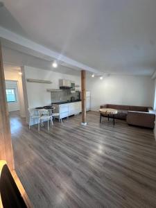 a living room with a couch and a table at Apartament Kiki MIELNO in Mielno
