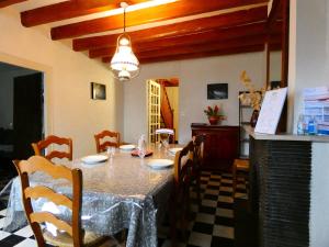 a dining room with a table and chairs at Escapade Paisible: Gîte pour 8 à Saint-Hilaire-sur-Yerre, Jardin Clos, Proche Chateaudun et Chartres - FR-1-581-131 in Saint-Hilaire-sur-Yerre