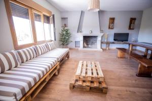 a living room with a couch and a table at Casa Rural Mario in Espeja