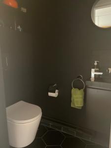 a bathroom with a white toilet and a sink at Panoramique vue NEW design proche Tour Eiffel in Paris +12 photos