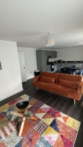 a living room with a couch and a rug at Cozy City Apartment in Rainham in Rainham