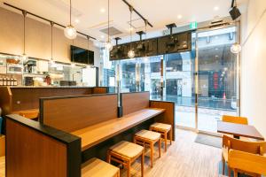 a restaurant with a wooden counter and chairs at APA Hotel Ueno Okachimachi Ekimae Minami in Tokyo