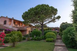 a garden with a tree and a building at La Casetta di Lidia by Wonderful Italy in Cannigione