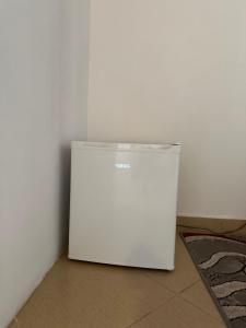 a white refrigerator sitting in the corner of a room at Villa Zefi Rrenc in Shkodër +11 photos