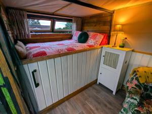 a small room with a bed in the middle of it at Highview Hideaway in Upchurch