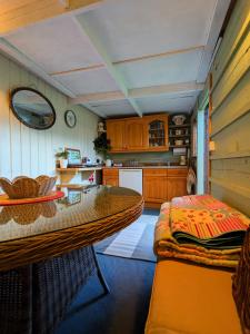 a kitchen with a table and a dining room at Highview Hideaway in Upchurch