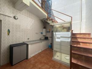 a kitchen with a sink and a staircase in a room at Mero Habitaciones in Cabo de Palos +16 photos