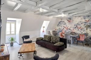 a living room with a couch and a table at Appartement de caractère, charme in Nevers