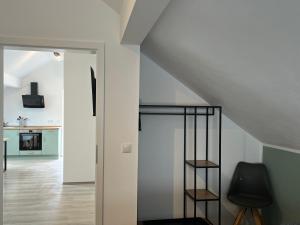 a room with a staircase and a black chair at Ferienwohnung Weins in Treis-Karden