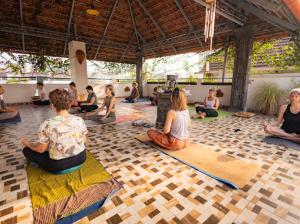 a group of people sitting in a yoga class at La Lune Fort Kochi in Cochin