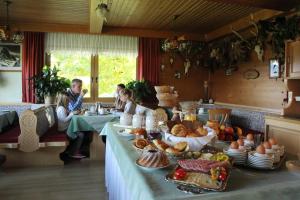 personas sentadas en una mesa con un buffet de comida en Hotel Tischlbergerhof, en Ramsau am Dachstein