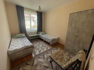 a room with two beds and a window at Dastan in Cholpon-Ata