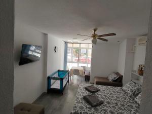 a living room with a bed and a ceiling fan at Agata 6 - 24h reception in Benalmádena