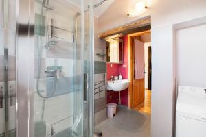 a bathroom with a glass shower and a sink at Maison Ninive in Aosta +24 photos